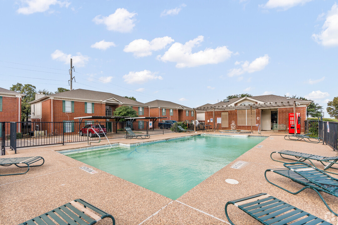 a pool with a pool table and chairs in it