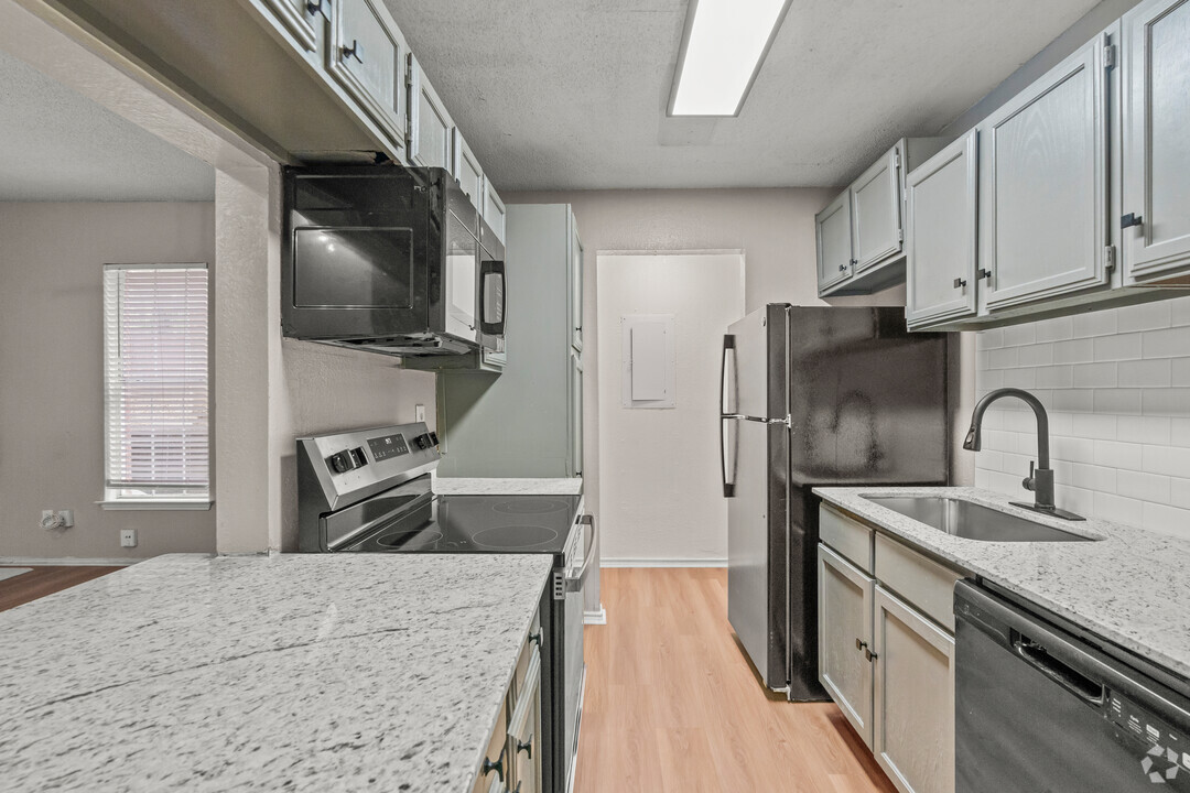 a kitchen with a stove top oven and a microwave